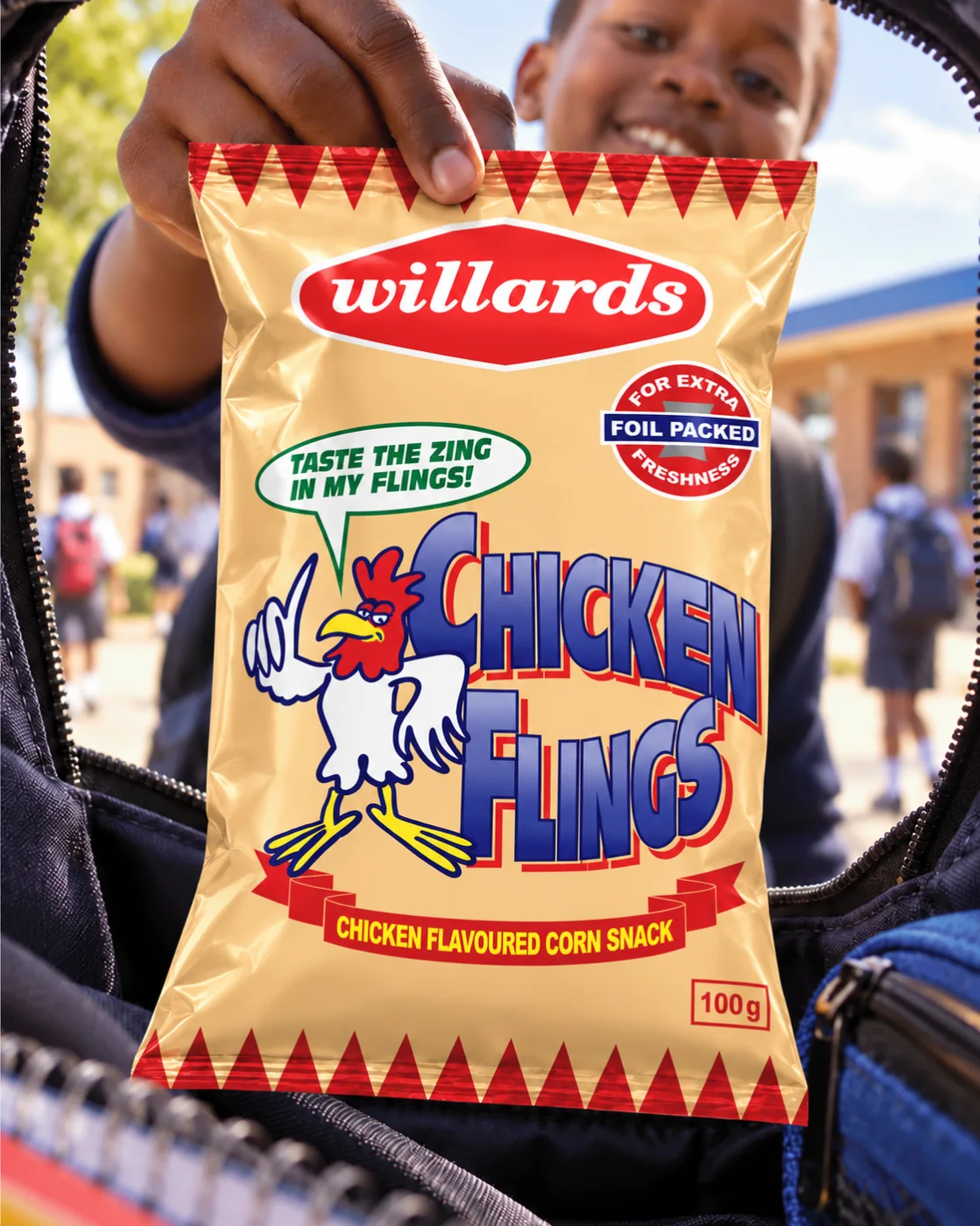 Boy holding a pack of Willards Chicken Flings